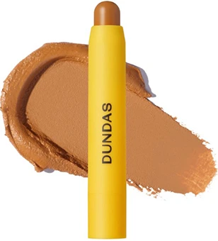 Image of a Dundas Undercover Enhancer Concealer Stick in yellow packaging, shown with a swatch of beige concealer color.