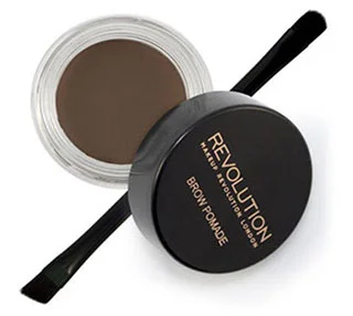 Open jar of Makeup Revolution Brow Pomade in a brown color with black brush and lid on a white background.