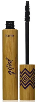 A tube of Tarte Cosmetics Gifted Amazonian Clay Smart Mascara, featuring a bamboo design and a black mascara wand, displayed with the cap off, showcasing its unique packaging.