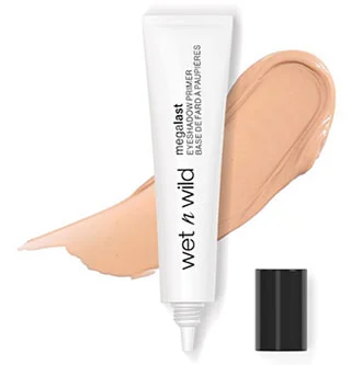 A tube of Wet n Wild Megalast Eyeshadow Primer positioned upright next to a swatch of the product, showcasing its smooth texture and light beige color.