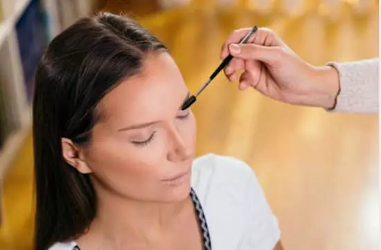 A woman applying eyeshadow